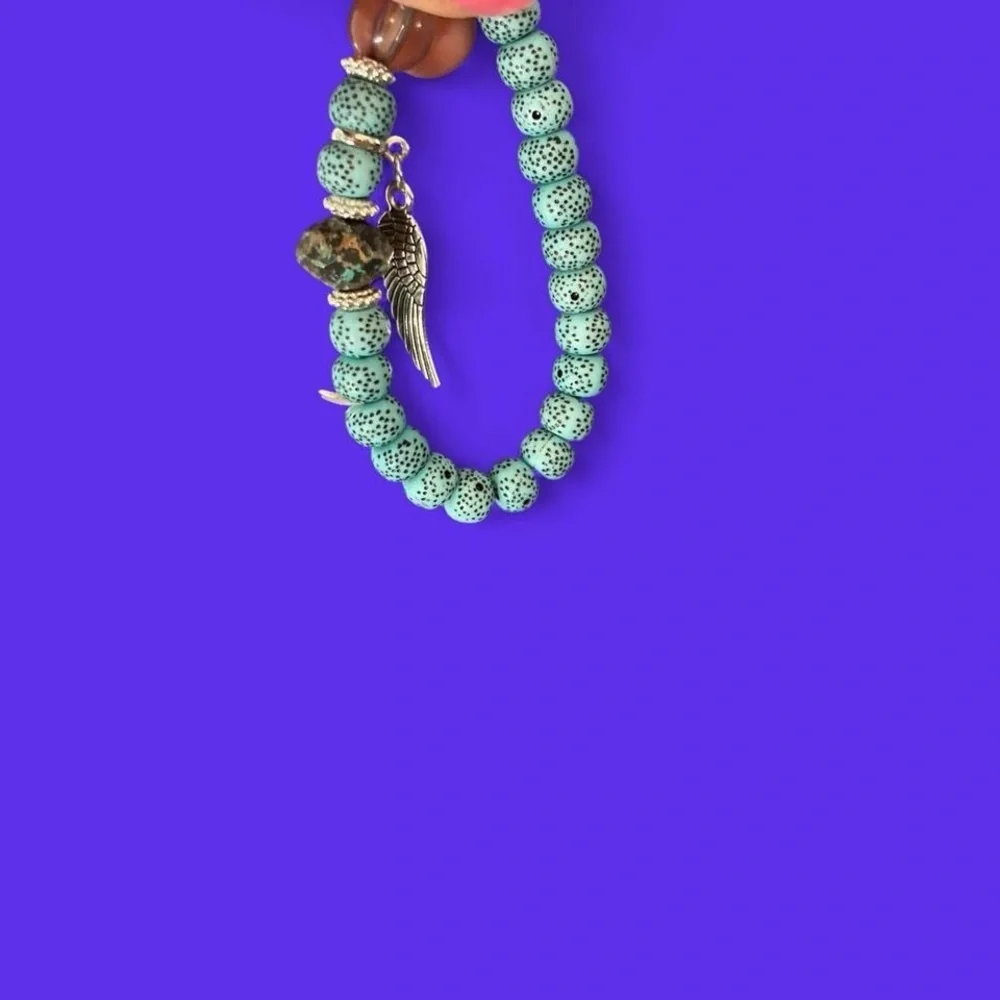 Greenish and silver boho beaded bracelet with Charms